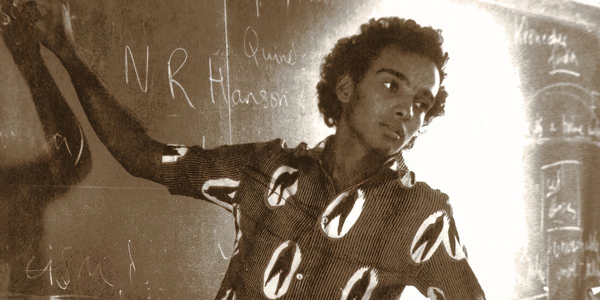 A young Kwame Anthony Appiah writing on a chalk board