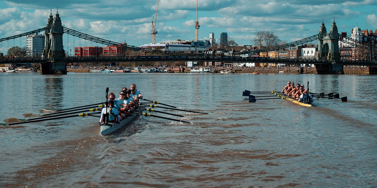 Two teams racing towards a bridge over a river