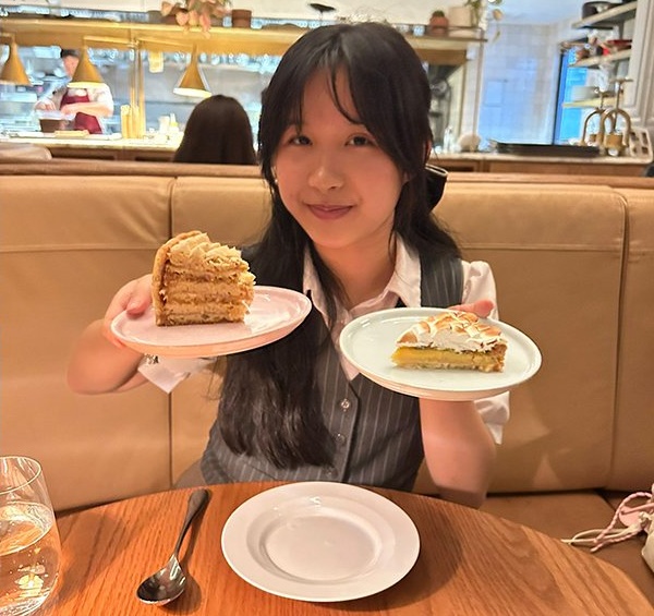 Natalie Sen-Yen Ng holding plated cake in each hand