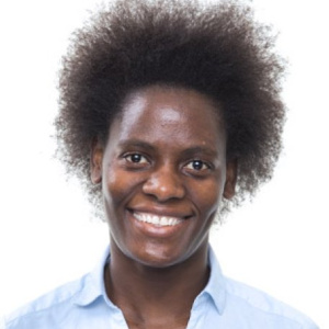 portrait photograph of dr priscilla day-walsh against a plain backdrop wearing a blue shirt