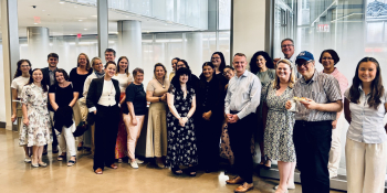 Cambridge in America staff posing for a photo in an office building lobby
