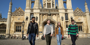 Students on a sunny day in front of an old college building