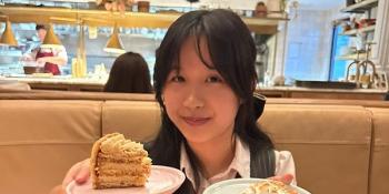 Natalie Sen-Yen Ng holding plated cake in each hand