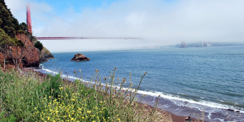 Blue sea cove with bridge in the background