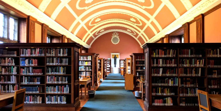 Book shelves inside a library with a curved orange roof