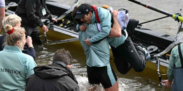 Sammy Houdaigui celebrating by hugging a team mate in a river.