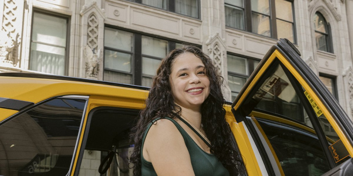 Woman getting out of taxi