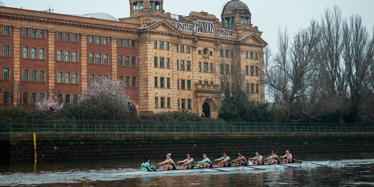 Cambridge team rowing passed Harods Furniture Depository.
