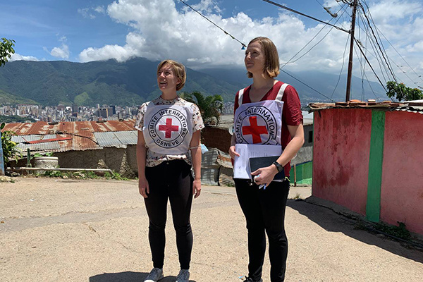 Emma Houiellebecq and another person in Venezuela wearing International Committee of the Red Cross bibs.