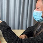 Woman works with robot