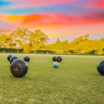 Bowling green with bowls and sunset