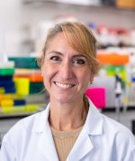 portrait photograph of Professor Amanda Sferruzzi-Perri wearing a white lab coat