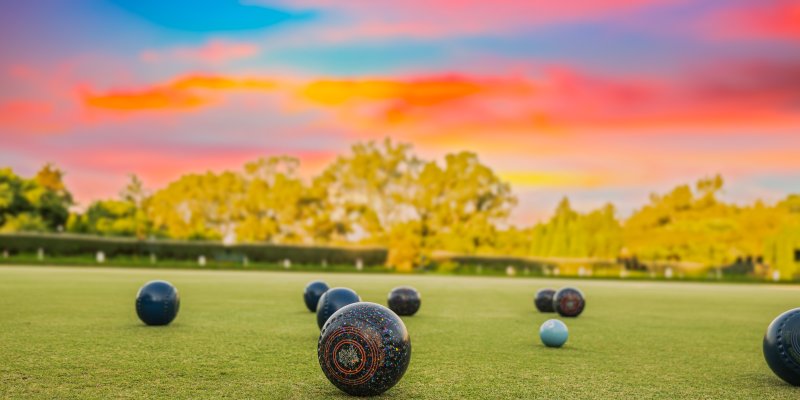 Bowling green with bowls and sunset