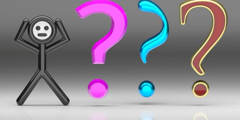 A stick man looking confused with three large question marks stood next to him