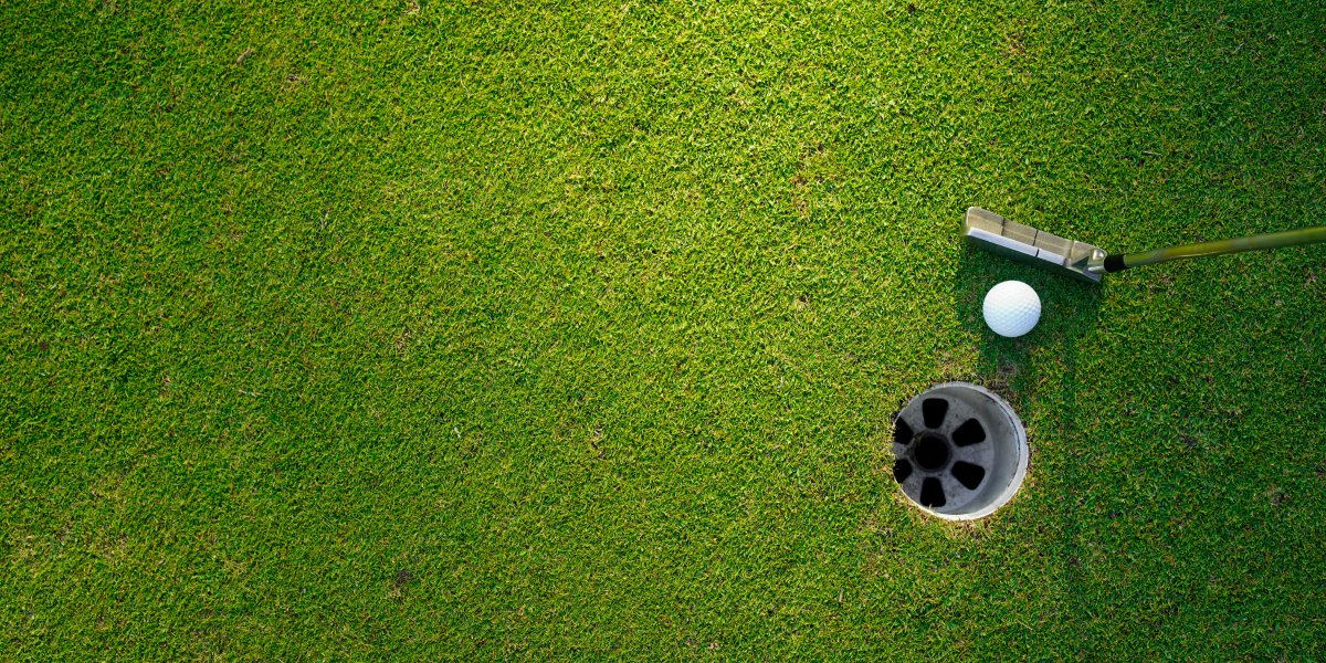 Golf green with golf club and hole