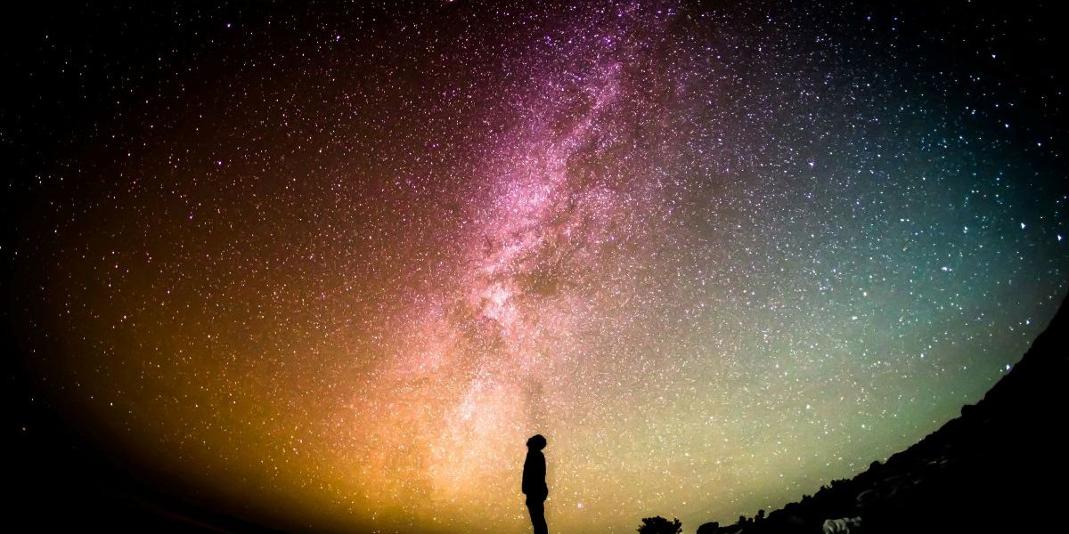 Shadow of a man against the night sky, stargazing